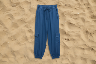Blue cargo pants on a sandy background