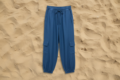 Blue cargo pants on a sandy background