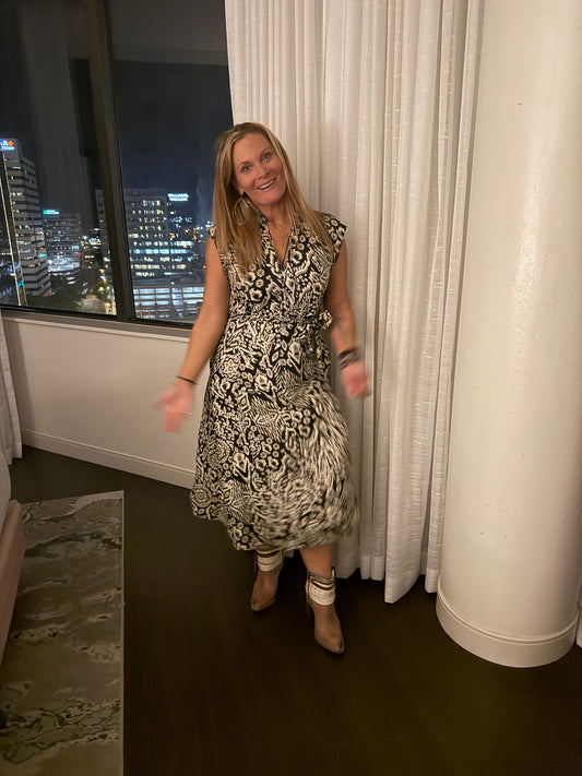 Black background dress with browns, whites design 
