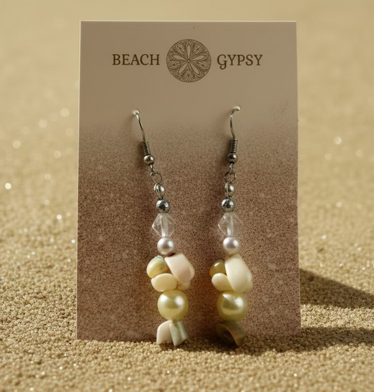 Beach Gypsy shell and pearl earrings on a branded card with a beach background