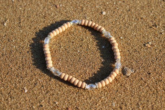 Wood and silver bead stretch bracelet in sand beach in Berlin, MD near Ocean City 