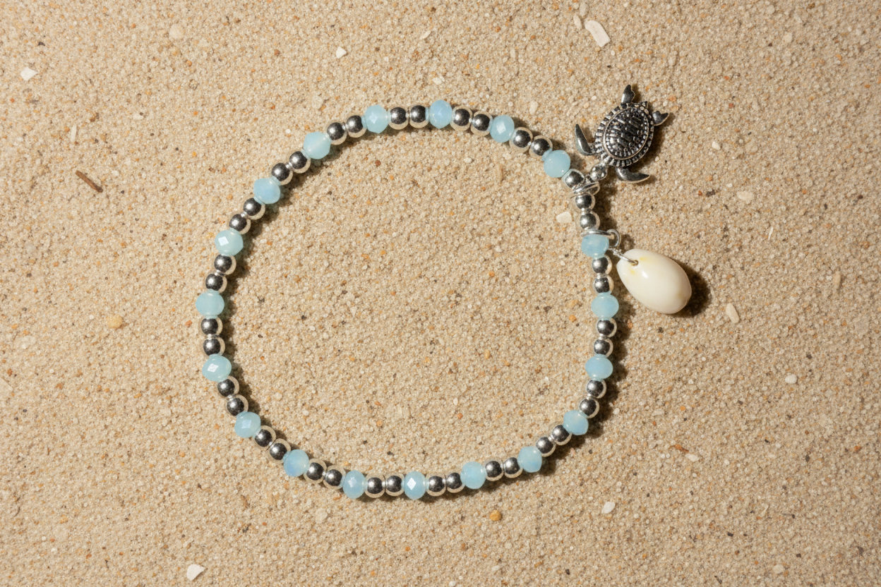 Turtle & Cowrie Shell beaded bracelet on sandy beach