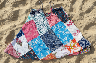 Patchwork skirt with floral patterns on a sandy surface