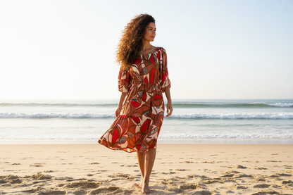 Woman on beach wearing Dragonfruit Peasant Dress 