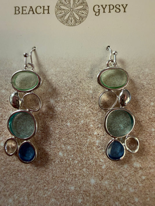 Pair of sea glass beach-themed earrings on a textured surface with 'Beach Gypsy' branding.