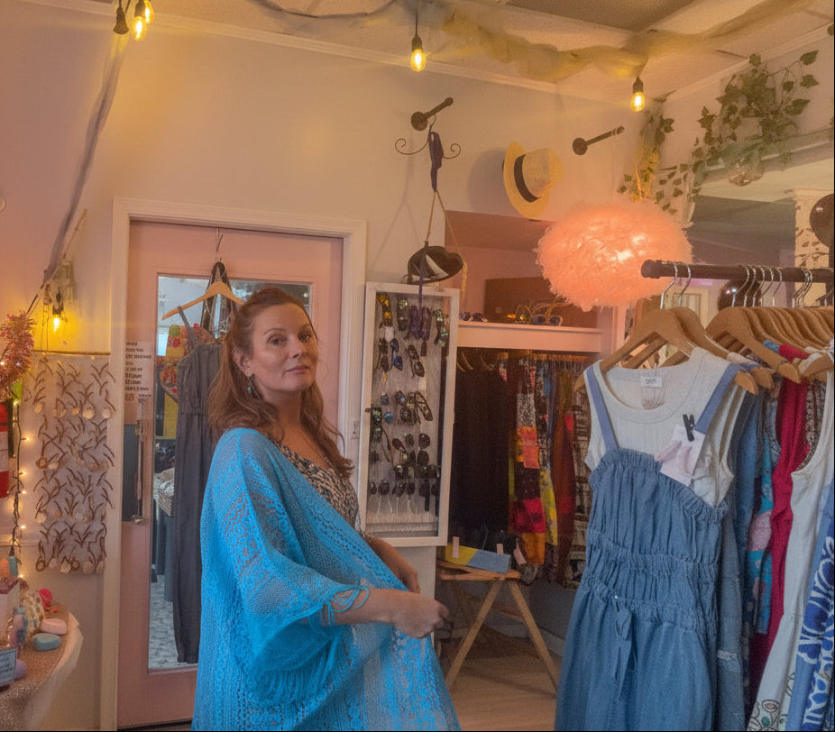 Woman in a blue fringe kimono standing in Beach Gypsy boutique in Berlin, MD