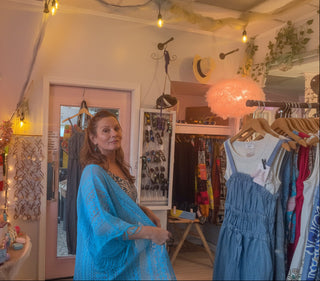 Woman in a blue fringe kimono standing in Beach Gypsy boutique in Berlin, MD