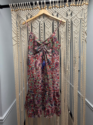 Floral dress on a hanger against a wooden floor background