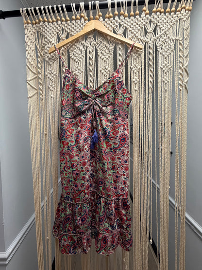 Floral dress on a hanger against a wooden floor background