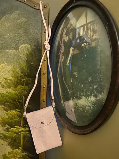 Pink purse displayed near antique photo