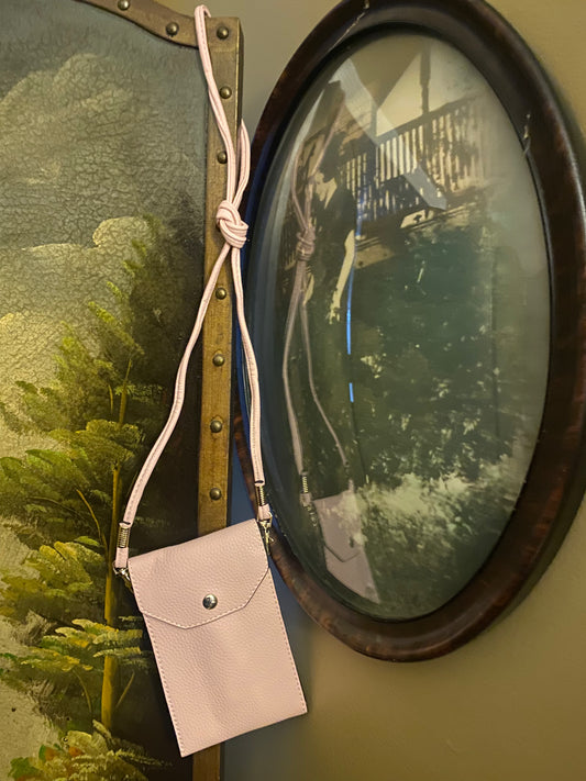 Pink purse displayed near antique photo
