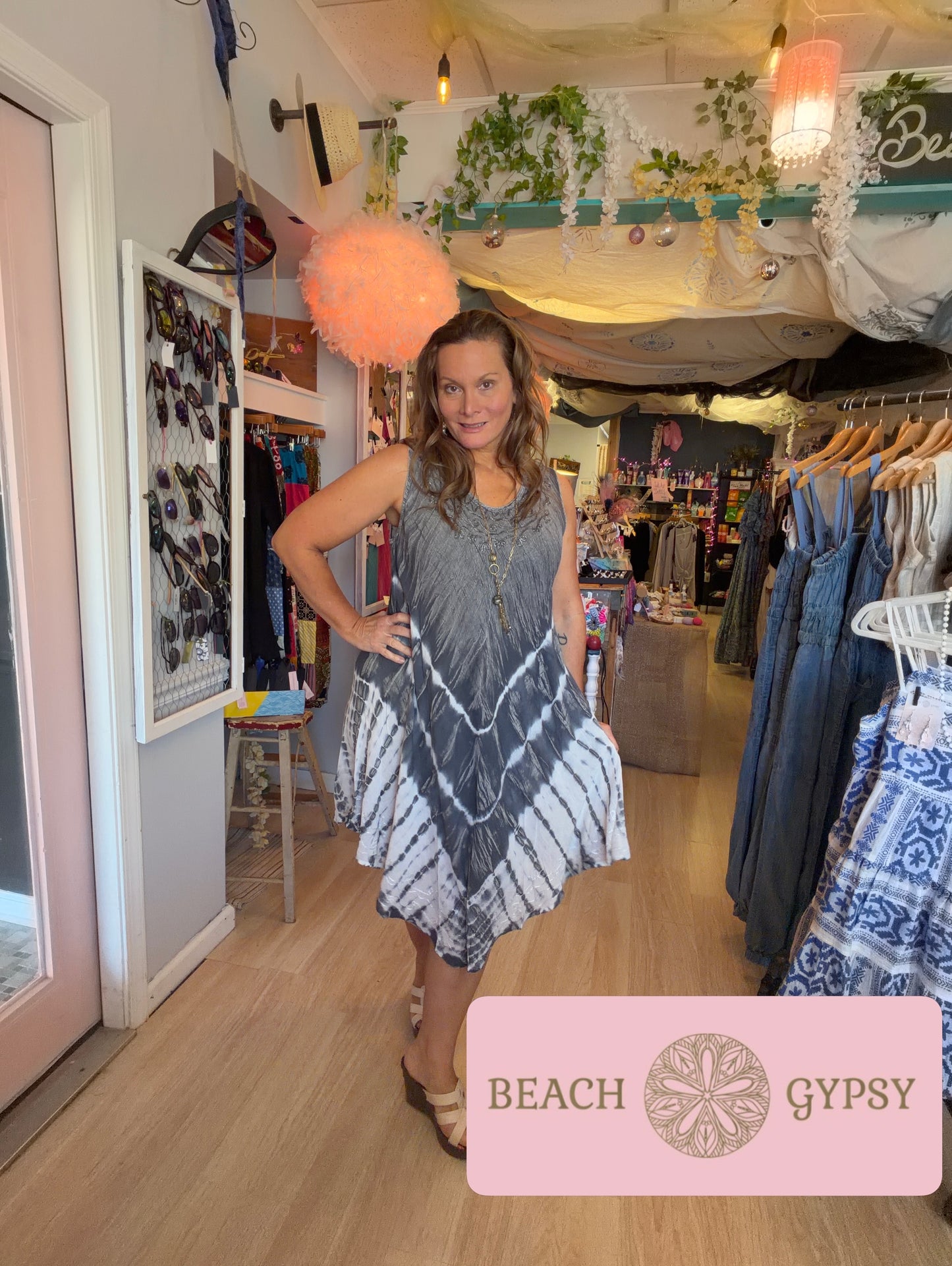 Woman wearing black tie dyes dress in a beautiful boutique 