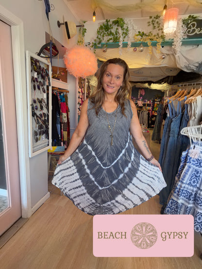 Woman wearing black tie dyes dress in a beautiful boutique 