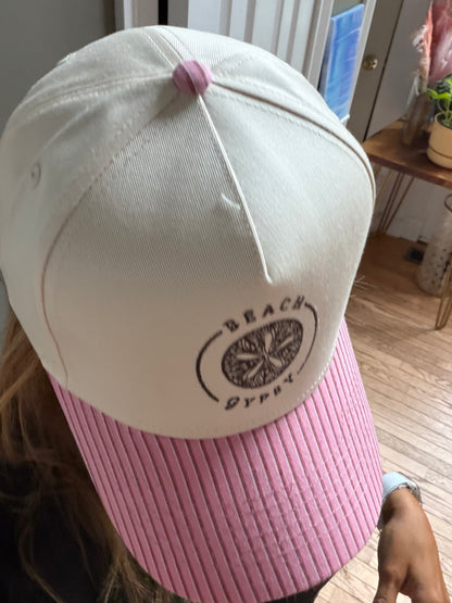 Beautiful woman showing a pink striped brim on a  canvas Beach Gypsy trucker hat