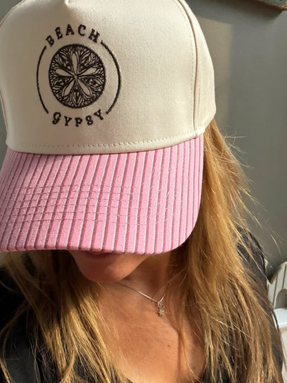 Beautiful woman showing a pink striped brim on a  canvas Beach Gypsy trucker hat