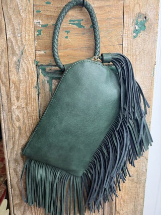 Back of olive green fringe wristlet bag showing zipper top, side tassel and braided handle