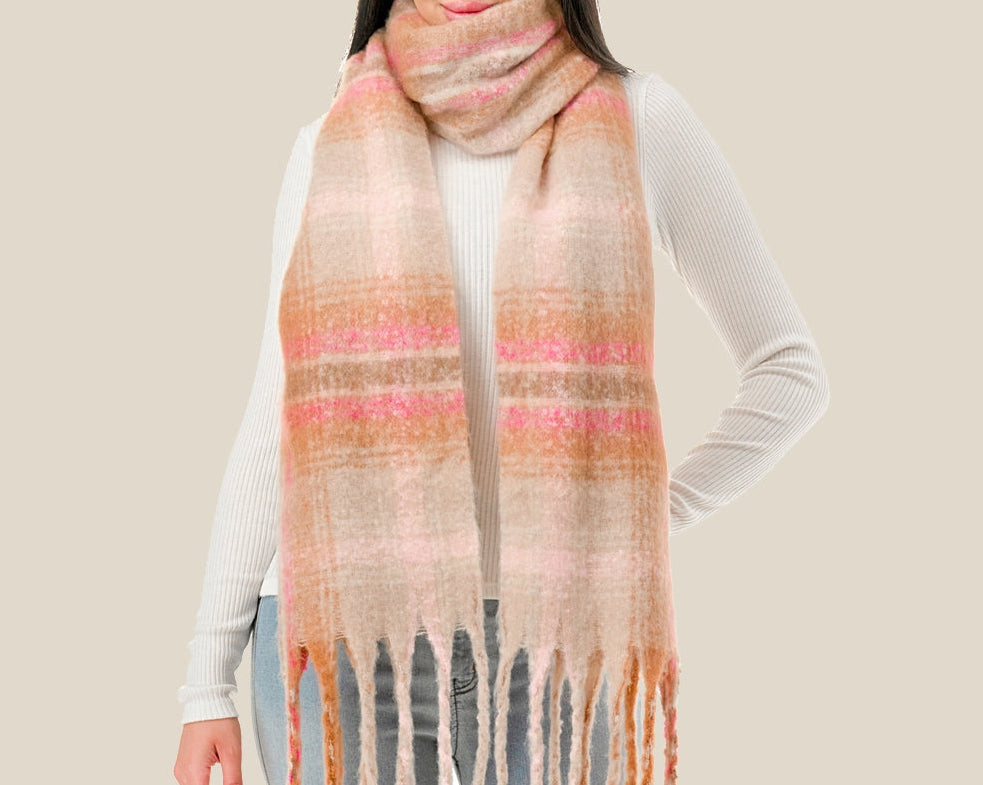 Woman wearing a plaid scarf with a neutral background