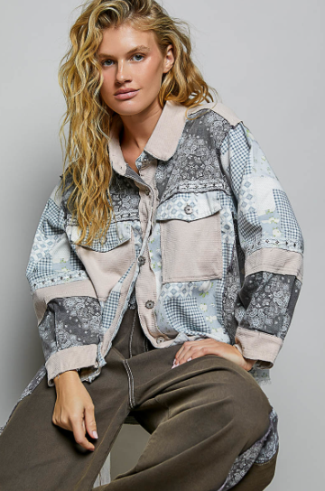 Woman with blong blonde hair sitting wearing a Patchwork Button-Down Shirt Jacket, Blue Multi