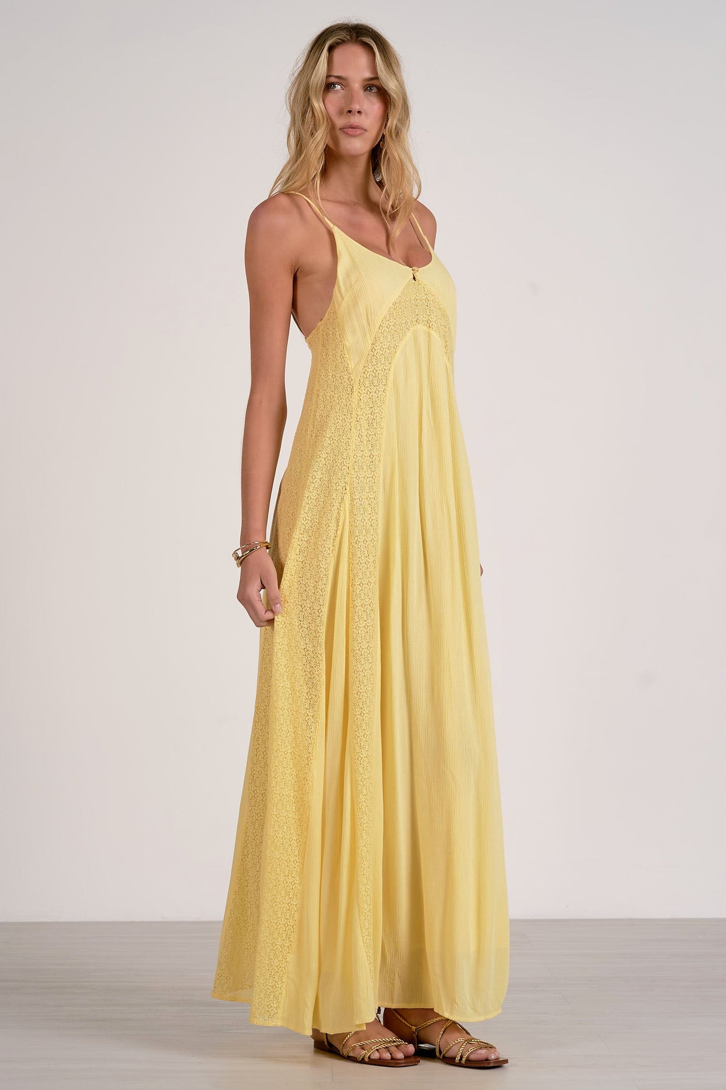 Woman wearing a yellow dress against a white background
