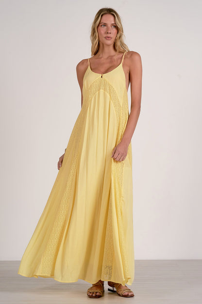 Woman wearing a yellow dress against a plain background