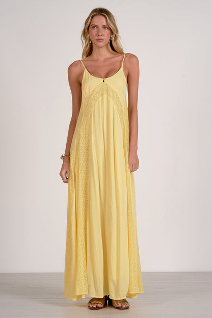 Woman wearing a yellow dress against a white background