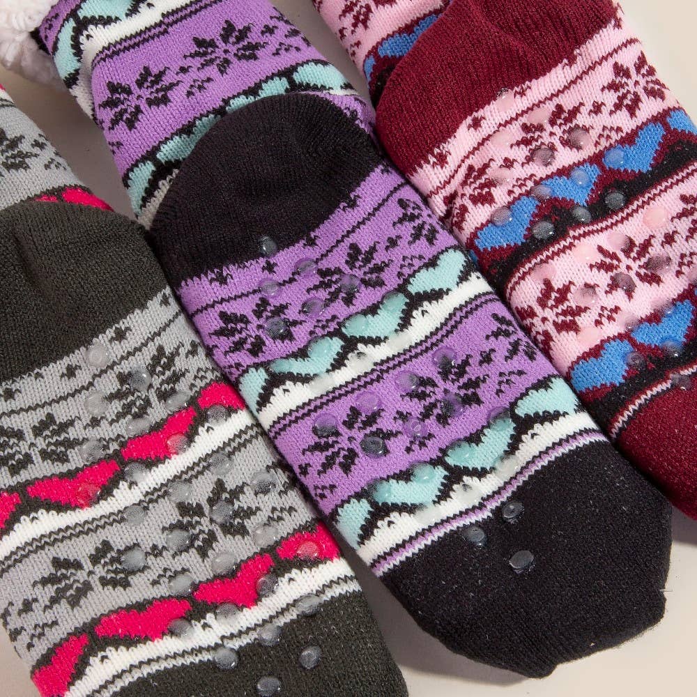 Colorful patterned socks with textured sole on a light background