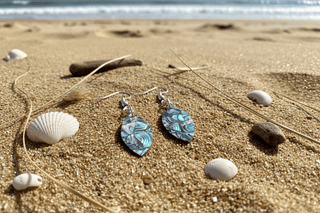 Close-up of Abalone Surfboard Dangle Earring dangle earrings laid flat, showing their beaded detail