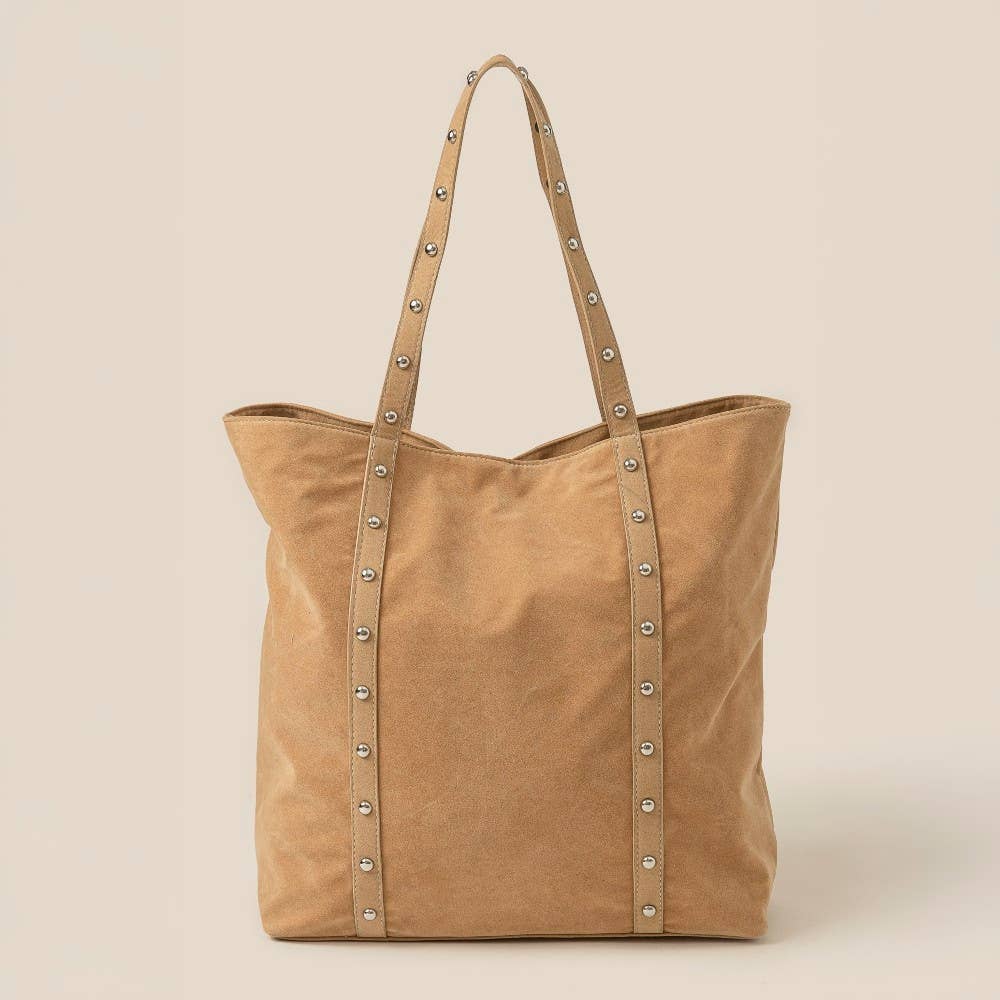 Tan tote bag with studded details on a beige background