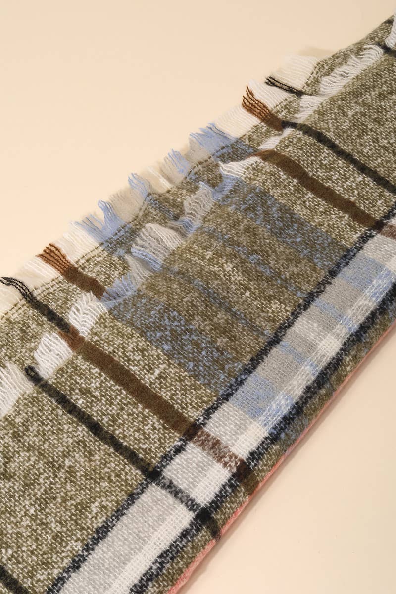 Plaid patterned rug with fringe on a beige background