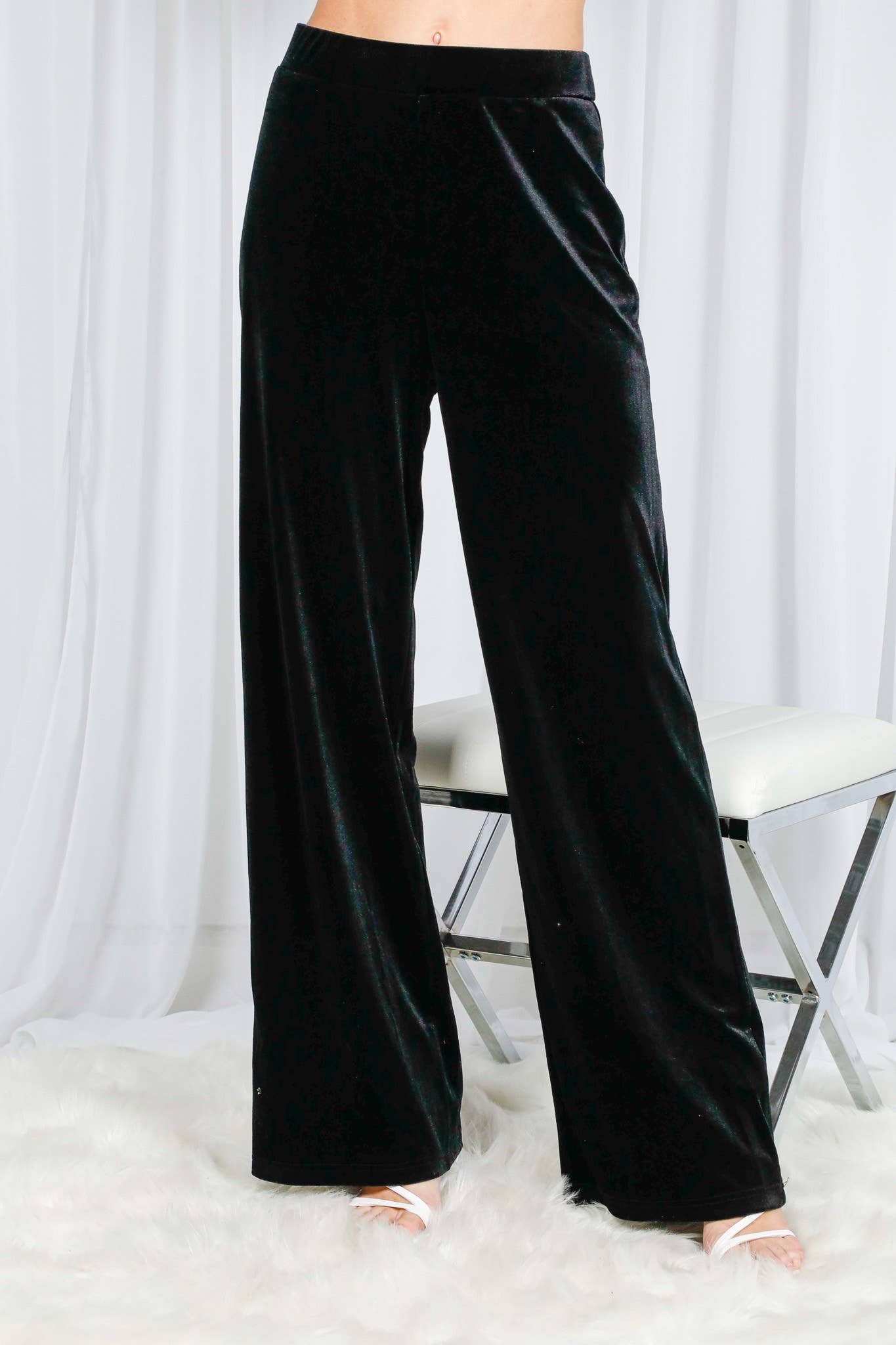 Black wide-leg pants worn by a person on a white background