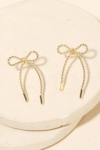 Close-up of Bow Tie Earrings dangle earrings laid flat, showing their beaded detail