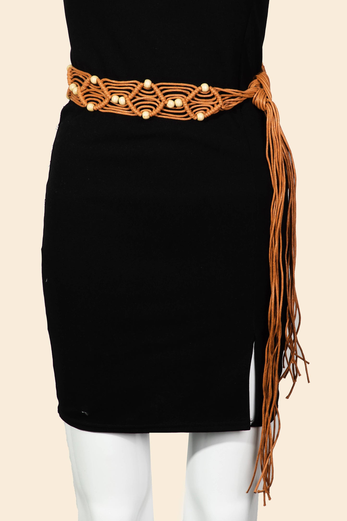 Black skirt with a brown belt and fringe on a beige background