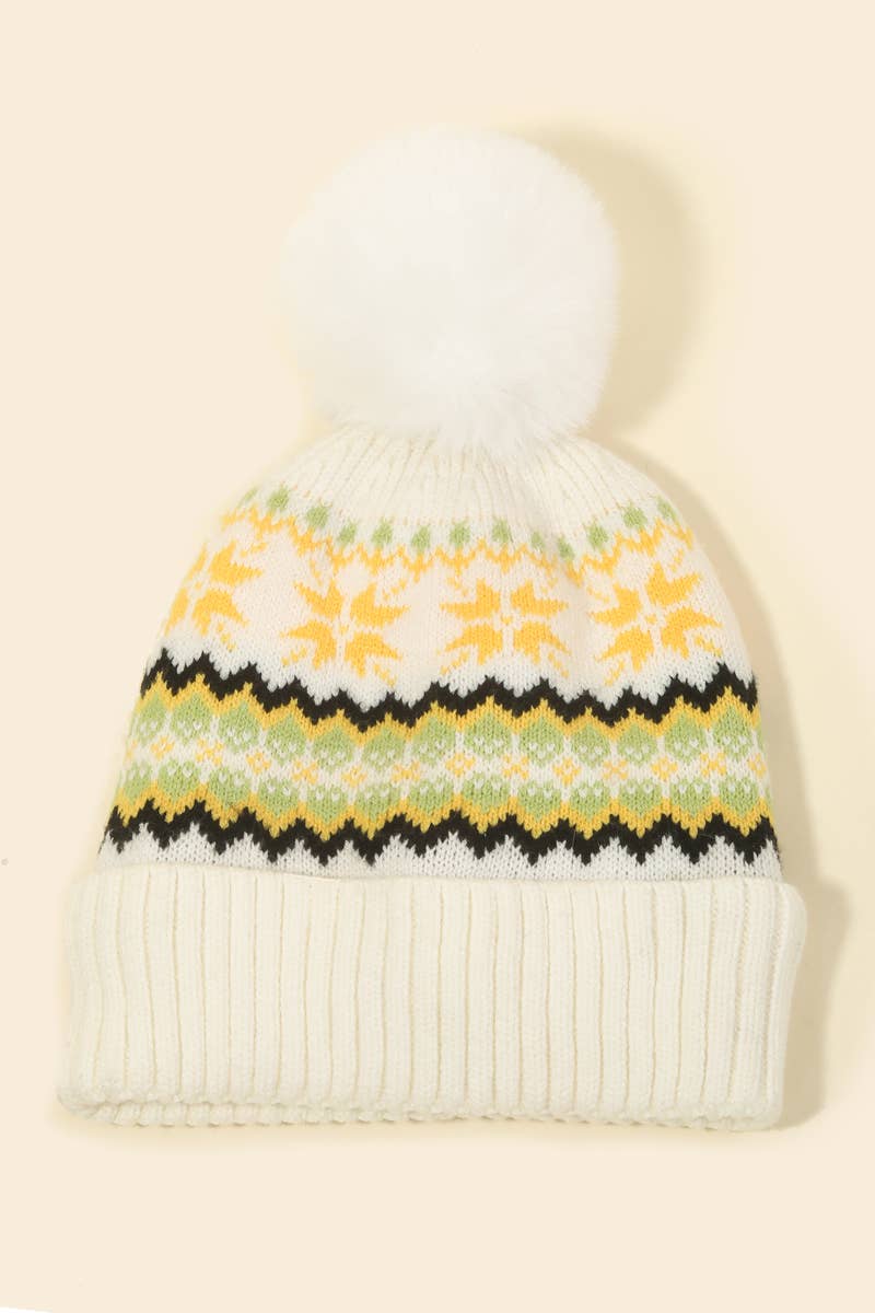 White knit beanie with floral pattern on a beige background