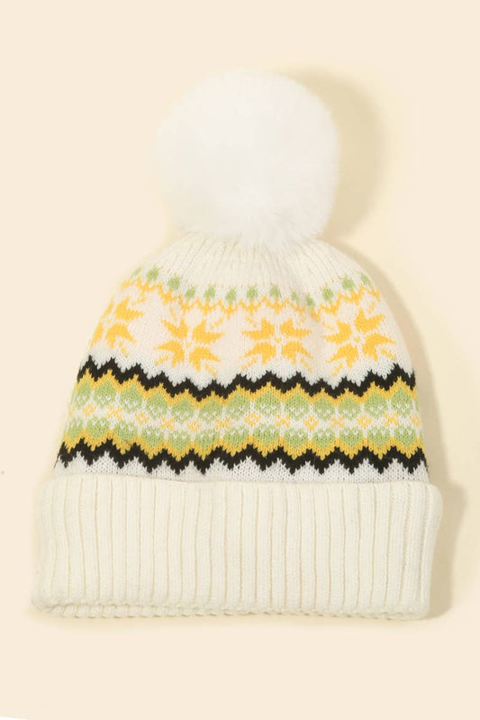 White knit beanie with floral pattern on a beige background