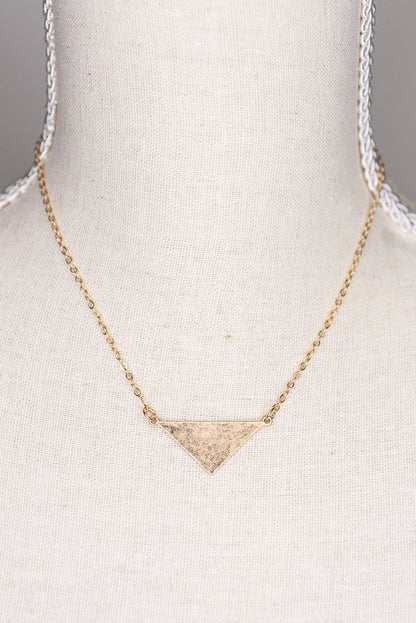 Gold triangle pendant necklace on a mannequin bust.