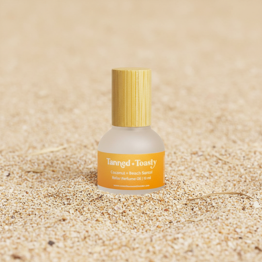 Tanned & toasty rollerball perfume on a Sandy background 