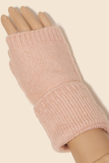 Pink knitted fingerless glove on a neutral background