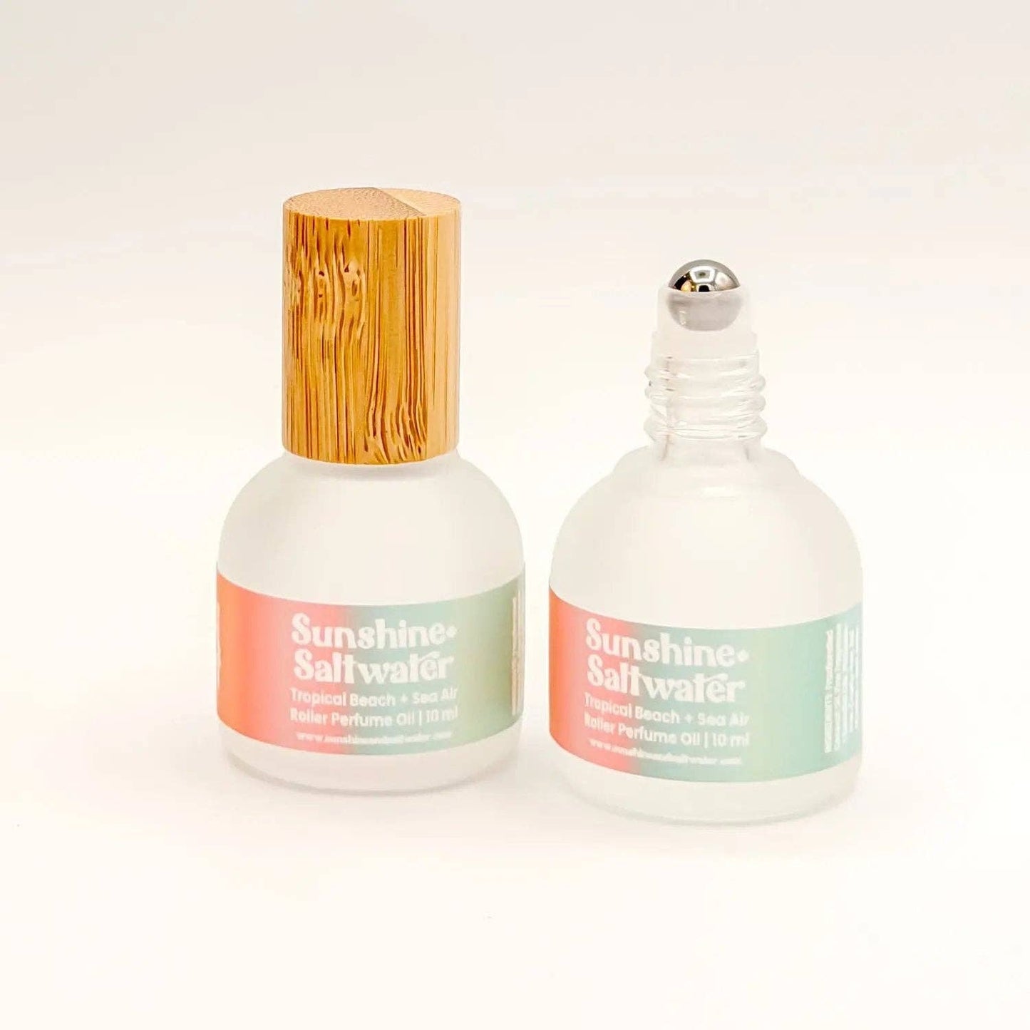 Two bottles of 'Sunshine Saltwater' perfume on a white background