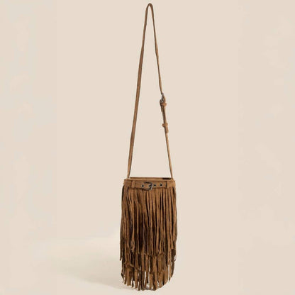 Brown fringe bag with a strap on a beige background