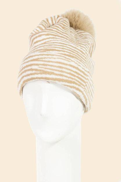 Beige and white striped beanie on a mannequin head against a beige background