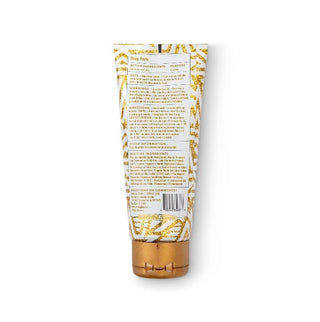 Gold and white tube with text on a white background