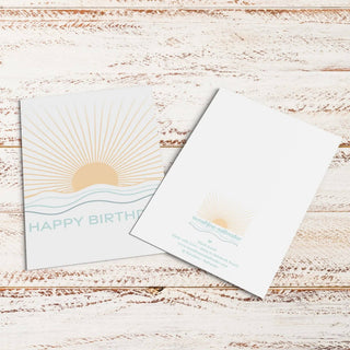 Happy Birthday Sun Rays Greeting Card shown face-up to display its illustrated coastal design