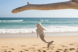Handcrafted Horizontal Mermaid Ornament made from natural coastal materials, displayed on a neutral surface