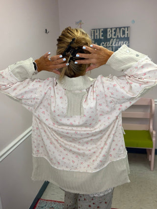 Ivory Floral Patch Jacket shown on a hanger or flat lay, highlighting its knit texture in ivory