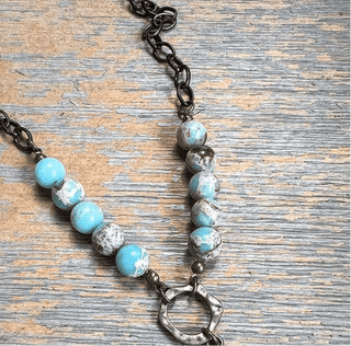 Juniper Necklace laid flat, highlighting its pendant design