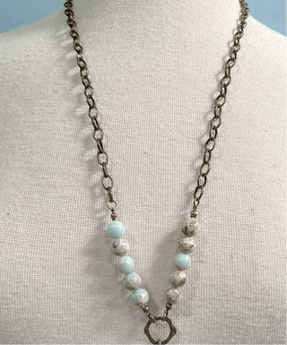 Juniper Necklace laid flat, highlighting its pendant design