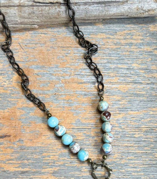 Juniper Necklace laid flat, highlighting its pendant design