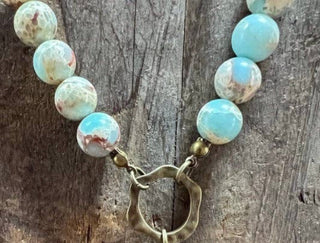 Juniper Necklace laid flat, highlighting its pendant design
