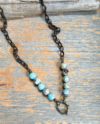 Juniper Necklace laid flat, highlighting its pendant design