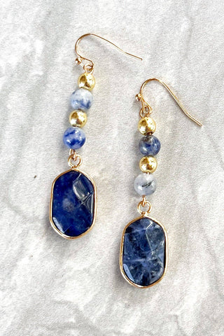 Close-up of Maggie Blue Sodalite Drop Earrings dangle earrings laid flat, showing their blue detail